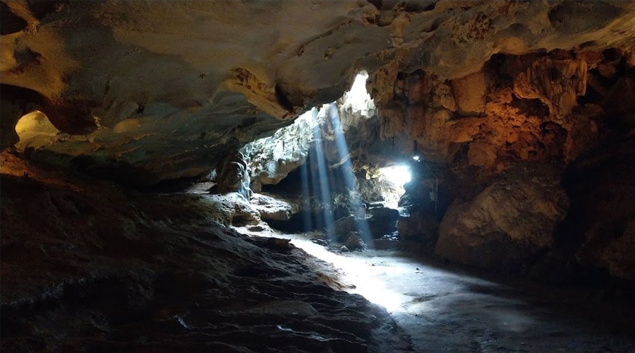 Sunlight streaming through the cave's ceiling of Thien Canh Son